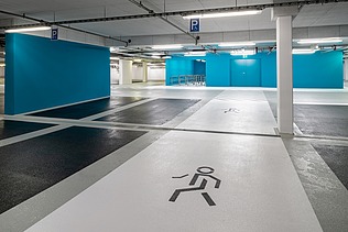 Photo of a person icon on the floor of an underground parking garage