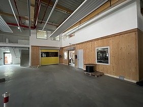 Foto des Innenausbaus einer Gewerbehalle. Man sieht LENO-Brettsperrholzwände und -decken.