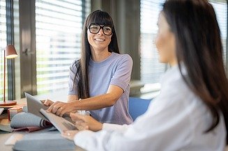 Two office staff having a discussion