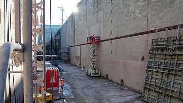 Photo of a wall of a sluice with pipes