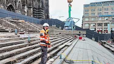 Photo of a man on the steps with a plate in his hand